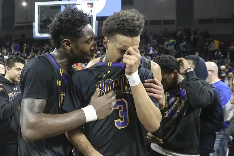 Roman Catholic’s Allen Betrand, left, and Lynn Greer III shed tears of joy after beating Bonner-Prendergast, 51-49, for the Catholic League Championship at the Palestra, Monday.