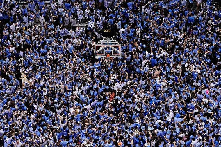 CHAPEL HILL, NC - FEBRUARY 20:  North Carolina Tar Heels fans storm the court after a win over the Duke Blue Devils during their game at the Dean Smith Center on February 20, 2014 in Chapel Hill, North Carolina. North Carolina won 74-66.  (Photo by Grant Halverson/Getty Images)