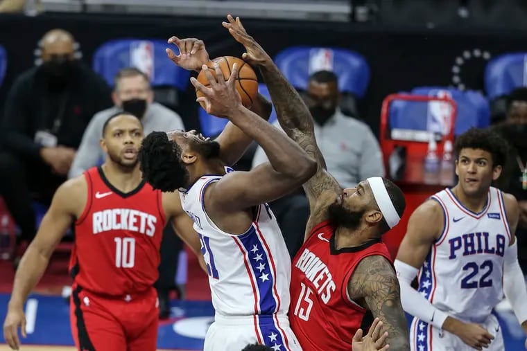 Joel Embiid gets blocked by Houston's DeMarcus Cousins during the fourth quarter.