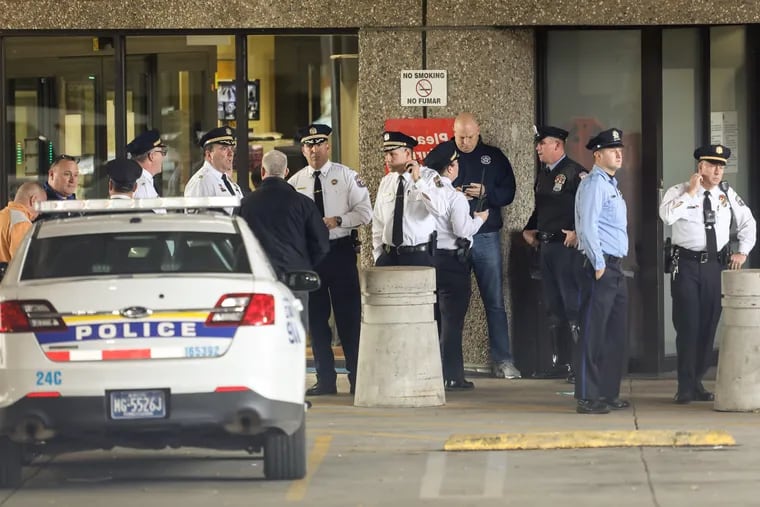 Philadelphia police officers gather outside the emergency room at Temple University Hospital on Wednesday. A fellow officer was shot in the Kensington section of the city.