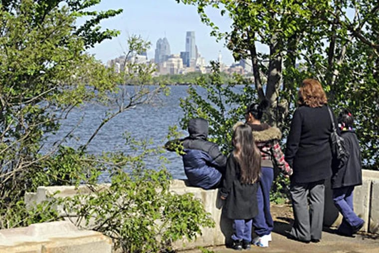 Before groundbreaking ceremonies for Phoenix Park, Theresa Banford, director of development for Sacred Heart School in Camden’s Waterfront South neighborhood, and some students take in the view across the Delaware. TOM GRALISH / Staff Photographer