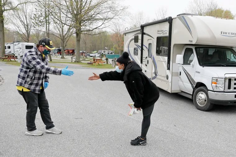 General Manager Dave Masarik (left) and Riticia Augusty, a physician's assistant at a Bronx hospital, observe social distancing as they say goodbye.  Augusty was about to drive the 32’ Freedom Elite motorhome, on loan free of charge from the Philadelphia South Clarksboro KOA Campground in South Jersey, back to her home on Staten Island. The campground, along with several other KOAs across the country, has partnered with RVs4MDs, which provides free housing for medical personnel amid the coronavirus crisis. Select KOA campgrounds throughout North America will be offering free RV use for doctors, nurses and other medical staff who are looking for alternate accommodations to avoid exposing their families
