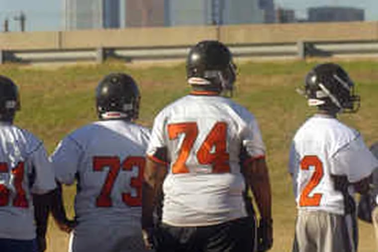 Lineman Kyle Smithson (74) towers over his Furness teammates. The Franklin Learning Center senior is playing organized football for the first time as part of a merged program.
