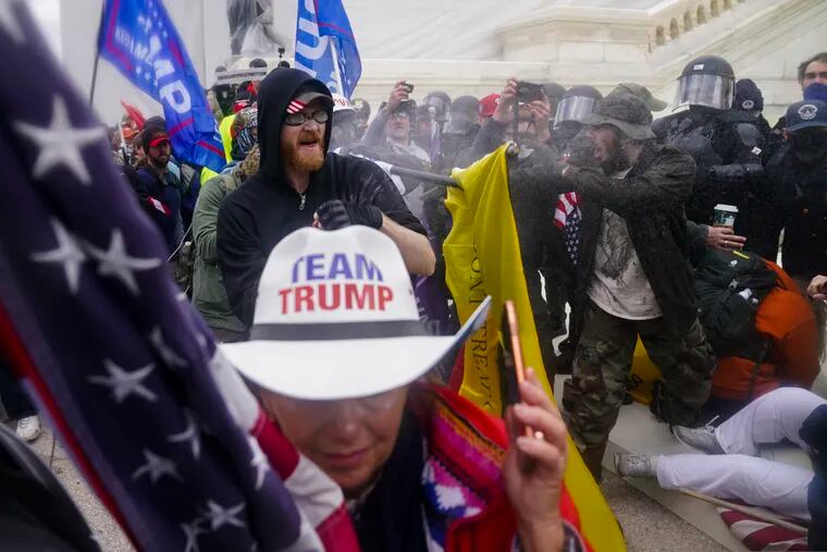 In this Jan. 6 photo, insurrections loyal to President Donald Trump try to break through a police barrier at the Capitol in Washington.
