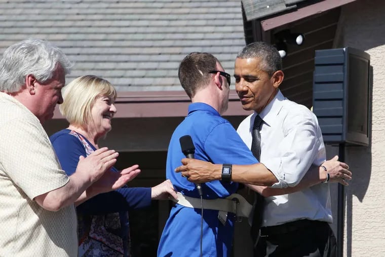 President Obama greets Sgt. 1st Class Cory Remsburg, with his father and stepmother, Craig and Elizabeth, at the wounded Army Ranger's new home.