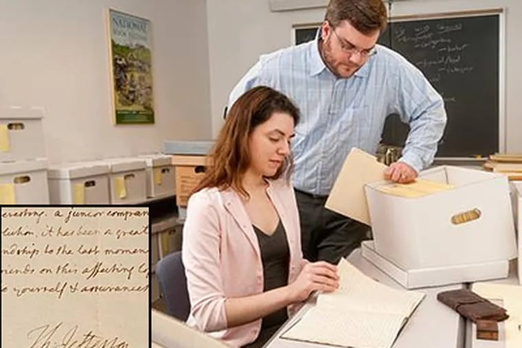 Graduate students Amanda Daddona and Matthew Davis sift through documents at the University of Delaware Library, where an 1808 letter written and signed by Thomas Jefferson was discovered. (Kathy Atkinson, University of Delaware)