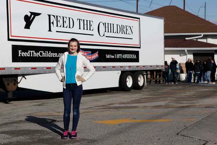 Brooke Rhea, 16, raised money for a tractor- trailer full of food and essentials to help 400 Ambler area families.  Feed The Children delivered the food to the Matie N. Dixon Community Cupboard where it was distributed. ( MICHAEL S. WIRTZ / Staff Photographer ) April 5, 2014.