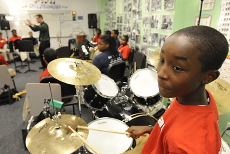 Seventh grader Zy’Mir Hutchinson plays the drums at KIPP Philadelphia Charter School, which has a successful jazz-funk band for beginners. (Clem Murray / Staff Photographer)