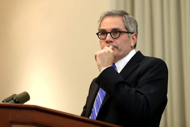 Philadelphia District Attorney Larry Krasner listens to a question during a news conference.