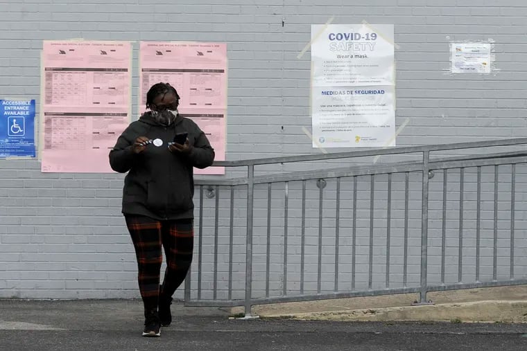 A woman leaves after voting at a West Philadelphia polling site on Election Day, Tuesday, Nov. 3, 2020, in Philadelphia. (AP Photo/Michael Perez)