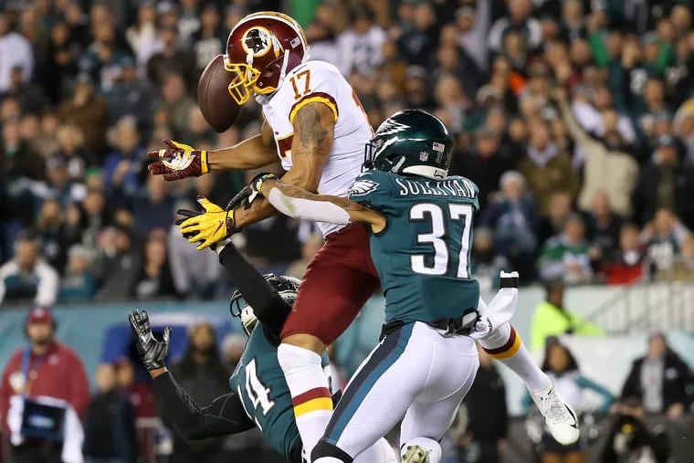 Tre Sullivan (right) breaks up a pass intended for Washington receiver Michael Floyd during the Eagles' win in early December.