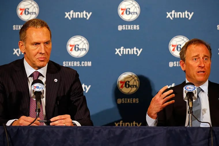 Sixers president of basketball operations Bryan Colangelo (left) listens to team managing owner Josh Harris during the news conference to announce Colangelo's hiring on April 20, 2016.