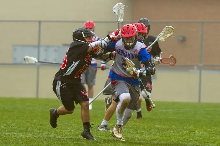 Archbishop Ryan's Jimmy Dolan (left) puts the pressure on Neshaminy's Dawson Obringer during a boys’ lacrosse game at Neshaminy High School in Langhorne, PA, Tuesday afternoon, April 3, 2018.  Neshaminy won 18-8.