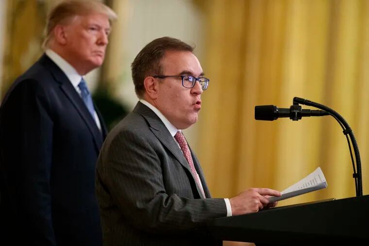 In this July 8, 2019, photo, President Donald Trump listens as Environmental Protection Agency Administrator Andrew Wheeler speaks during an event on the environment in the East Room of the White House in Washington.
