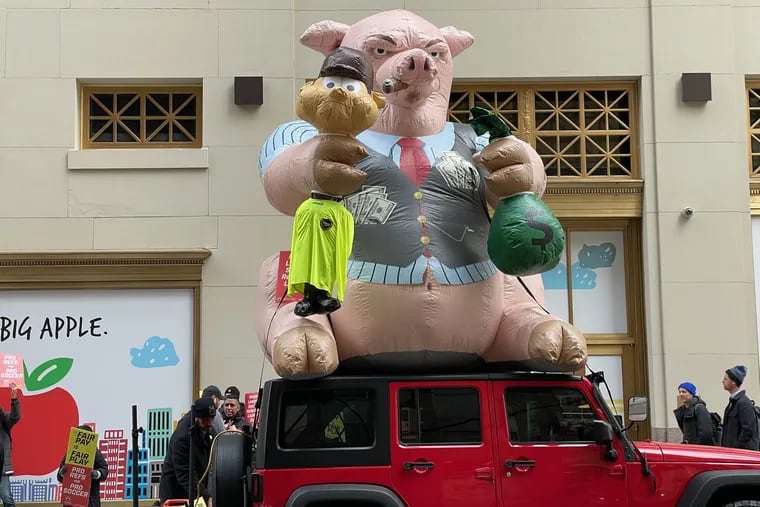 The referees union's protest outside MLS headquarters included an inflatable pig that was brought by members of a New York-area Teamsters local.