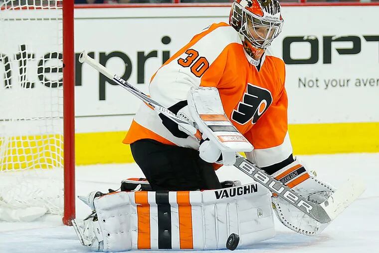 Flyer goalie Michal Neuvirth watches the puck during the second period.