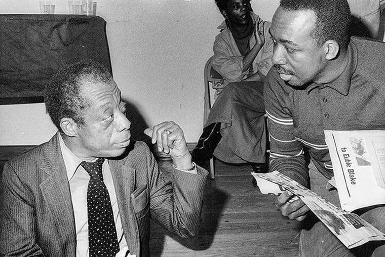 The novelist and essayist James Baldwin (left) talks to James G. Spady at the African American Museum in Philadelphia in March 1986.