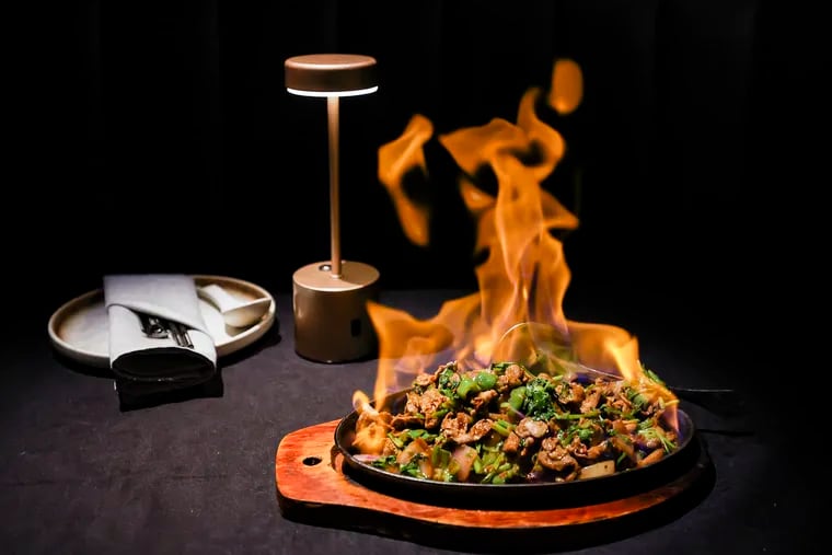 The cumin lamb on a sizzling plate is set afire at Jiang Nan restaurant in Chinatown.