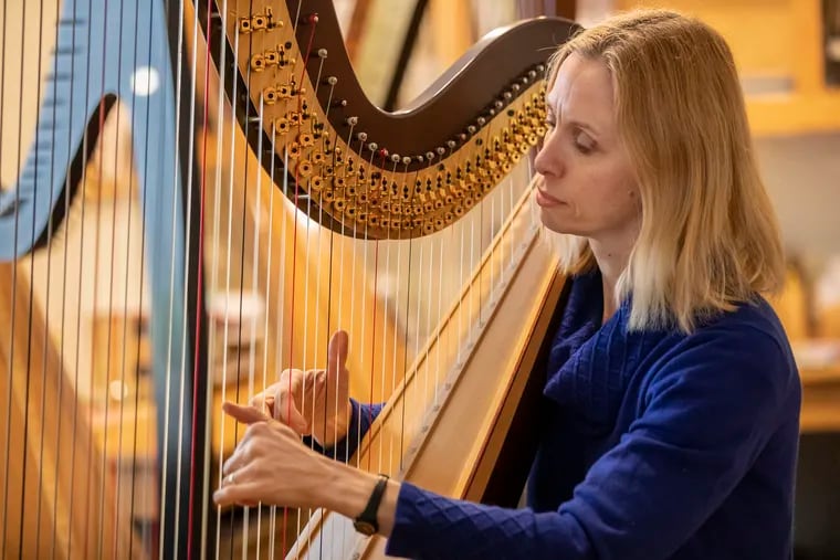 Mindy Cutcher plays her harp in her studio, that is just off of her garage, in her Oreland, PA home on April 14, 2020.   She is also giving lessons via skype, zoom or facebook live to her students during the coronavirus pandemic.