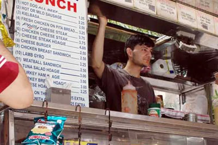 Aurang Zeb Khan of Zeb's Best food truck,on the corner of 7th and Market streets, gets a brief break during the lunch rush.
(James Heaney / Staff Photographer)
