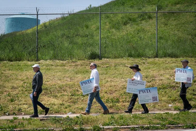 (Left to Right) Hilary Langer, chairman of the East Falls Community Council zoning committee, Paul Elia, Frances Bourne, and  Bill Hoffner, shown here next to the Queen Lane Water Treatment plant, in Philadelphia, Monday, April 29, 2024.