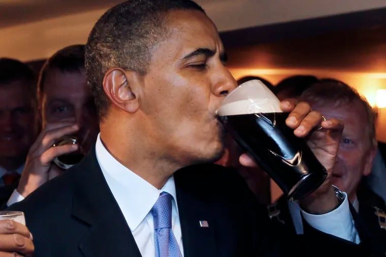 U.S. President Barack Obama drinks Guinness beer as he meets with local residents at Ollie Hayes pub in Moneygall, Ireland, the ancestral homeland of his great-great-great grandfather, in 2011.