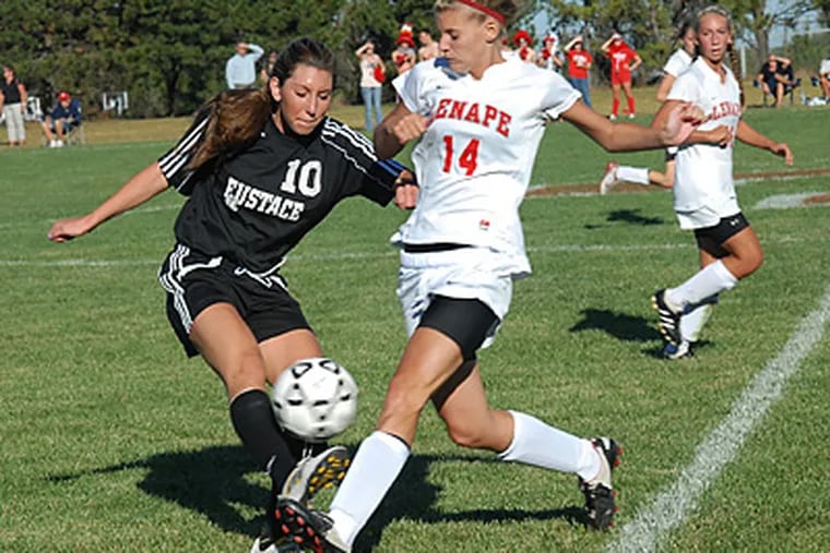 Bishop Eustace's Brittney Stone, left, goes in for a tackle against Lenape's Dunfee McKenna.  (April Saul / Staff Photographer)