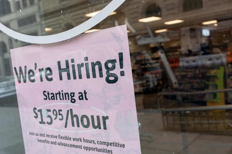 A "We're Hiring" sign is displayed in the window of a store in Washington, DC, on Feb. 2, 2022. (Stefani Reynolds/AFP via Getty Images/TNS)