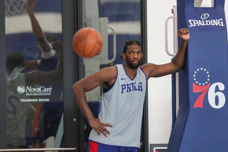 Joel Embiid, here watching from the sideline during a drill Wednesday, was a full participant in Thursday's practice.