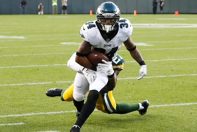 Eagles running back Donnel Pumphrey fights off a Green Bay safety Josh Jones during the first-quarter in a preseason game at Lambeau Field.