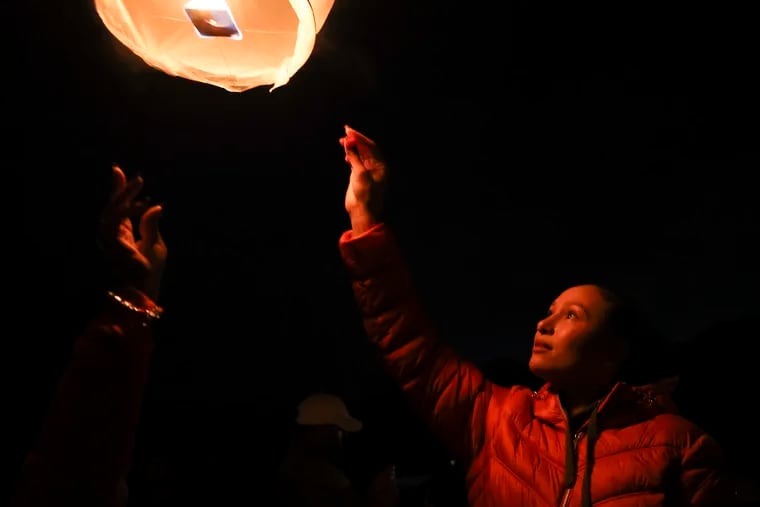 Lauren Alwan, sister of Jarred Alwan, releases her lantern for her brother during a celebration for what would have been his 30th birthday at the Berlin Cemetery in Berlin, NJ on Friday, Nov. 10, 2023. Jarred Alwan was as former Temple football star under coach Matt Rhule who had Stage II CTE when he died earlier this year. The family got the finding recently after donating Jarred’s brain to Boston University’s Brain Bank.