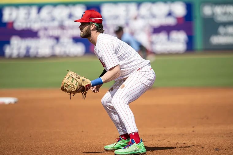 The Phillies’ Bryce Harper plays first base in his spring debut on Wednesday against the Braves.
