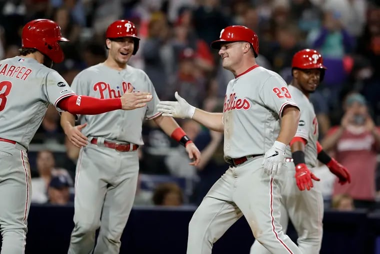 Jay Bruce (23) is greeted by teammates Bryce Harper (left), J.T. Realmuto and Jean Segura (right) after hitting a grand slam during the fifth inning against the Padres on Tuesday.