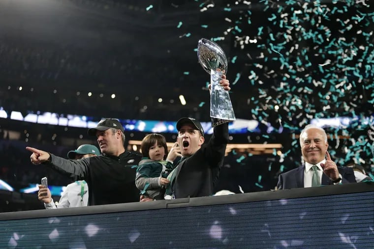 Eagles general manager Howie Roseman (center) in better days: hoisting the Lombardi Trophy following the Eagles' 31-33 victory over New England in Super Bowl LII.