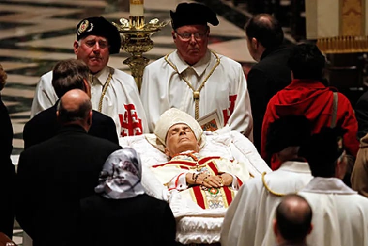 Mourners view the body of Cardinal John Patrick Foley at the Cathedral Basilica of SS. Peter and Paul. The local native served at the Vatican. (Laurence Kesterson / Staff Photographer)