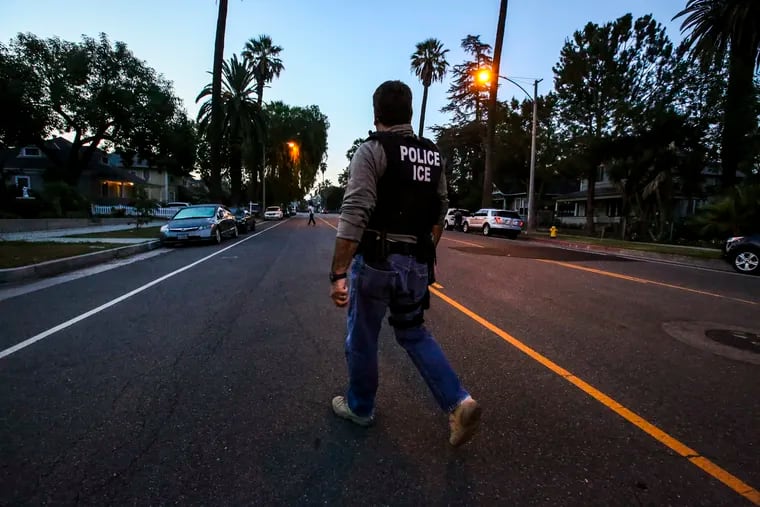 Jorge Field of ICE Enforcement and Removal Operations walks on his way to raid and apprehend an immigrant without legal status who may be deportable on Aug. 12, 2015 in Riverside, Calif. At least 26 Kern County farmworkers were detained for deportation proceedings as part of a mass sweep last week across Central and Northern California that federal officials said was targeted at convicted criminals. (Irfan Khan/Los Angeles Times/TNS)