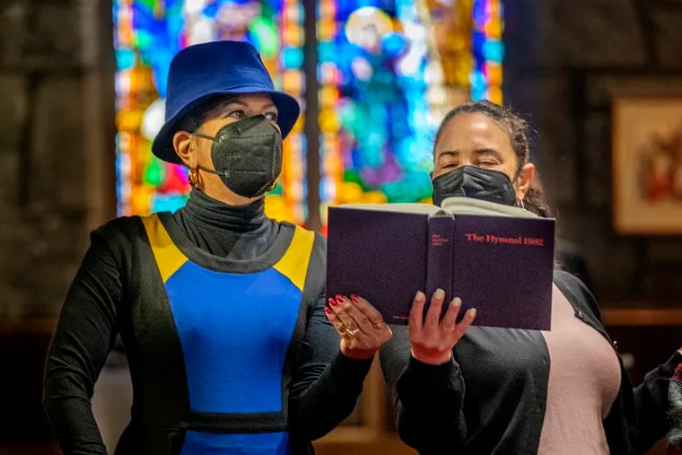Denise McDaniel Henderson (left) and Debra Joell (right) wear masks during mass at the Historic African Episcopal Church of Saint Thomas in Overbrook Apr. 10, 2022. COVID has killed more than 5,000 Philadelphians. St. Thomas pastor Martini Shaw says members will have to keep masking at in-person services for the foreseeable future. “Our 40 days of Lent, the theme has been emerging from the wilderness with Jesus,” Shaw said. “We still feel like we’re emerging.”