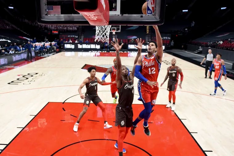 Philadelphia 76ers forward Tobias Harris drives to the basket on Portland Trail Blazers forward Harry Giles III during the second half.