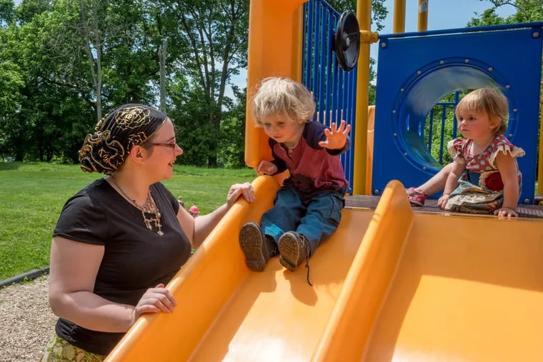 Caitlan Coleman spends time with her children, Dhakwoen, center, and Ma'idah, at a playground.