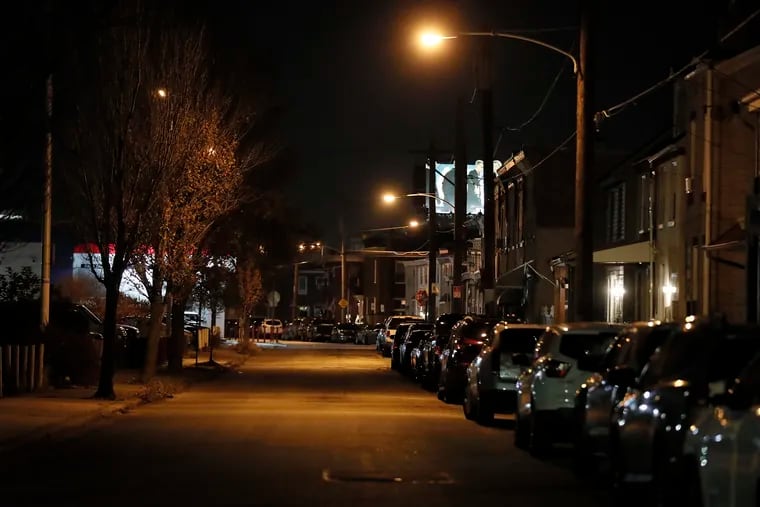 A streetlight can be seen illuminated on the 5300 block of Eadom Street in Philadelphia in November 2021. The city is undertaking a large project to replace every streetlight in the city with an LED light.