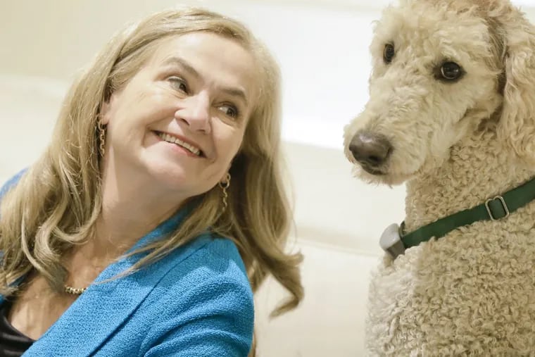 Annie McKee, author of “How to be Happy at Work,” with her labradoodle, Keik.