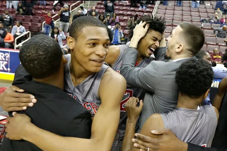 Imhotep's #01 Dahmir Bishop (left) celebrates with teammates at the end of the Imhotep vs Sharon HS Boys Class 4A PIAA State Championship basketball game at the Giant Center in Hershey, Pa. on March 26, 2018. Imhotep won 71-35.  ELIZABETH ROBERTSON / Staff Photographer