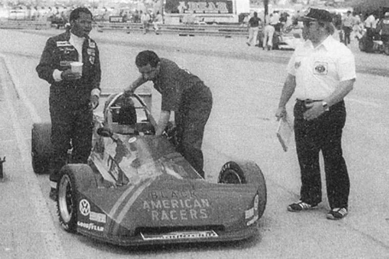 Tommy Thompson (left) looks up the track at the Milwaukee Mile in Wisconsin as Bob Merritt, a friend of Thompson's manager, makes a last-minute adjustment. Two weeks later, Thompson raced at Trenton Speedway and died after a crash, halting his ambition of integrating racing.