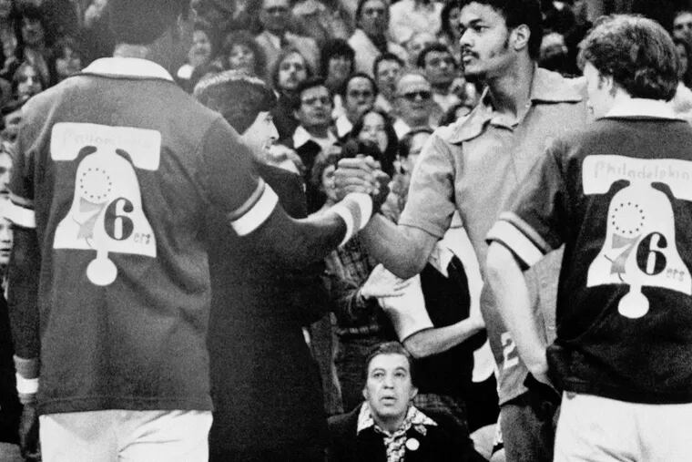 Maurice Lucas, right, of the Trail Blazers shakes hands with Darryl Dawkins of the 76ers prior to the start of Game 3 of the NBA Finals on May 29, 1977.  Lucas and Dawkins were tossed out of Game 2 for fighting and were fined $2,500 each. (AP Photo)