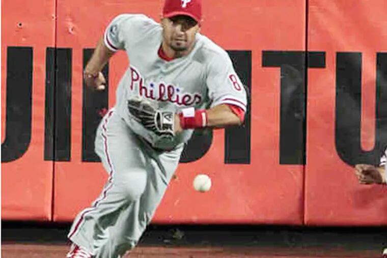 Centerfielder Shane Victorino chases ball after Raul Ibanez attempted to make catch on Carlos Beltran's hit. (AP)