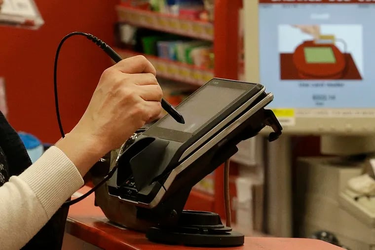 A woman pays by credit card at a retail store in California in this 2013 file photo.
