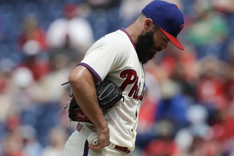 Phillies pitcher Jake Arrieta looks down before getting replaced in the sixth inning agains the Milwaukee Brewers on Saturday.