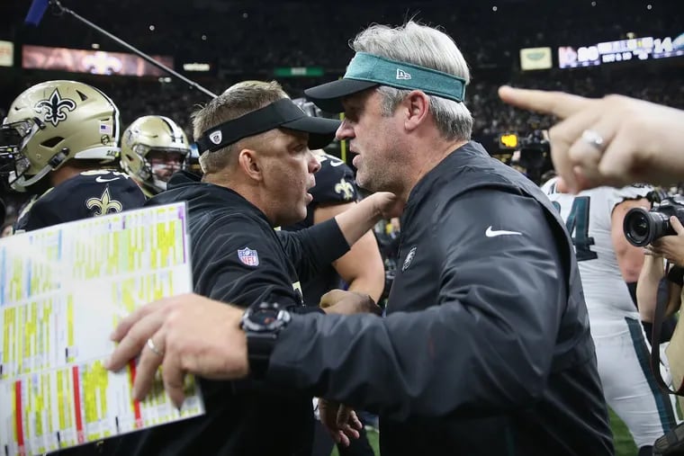 Doug Pederson (right) and Sean Payton embrace after the Eagles' loss to the Saints.