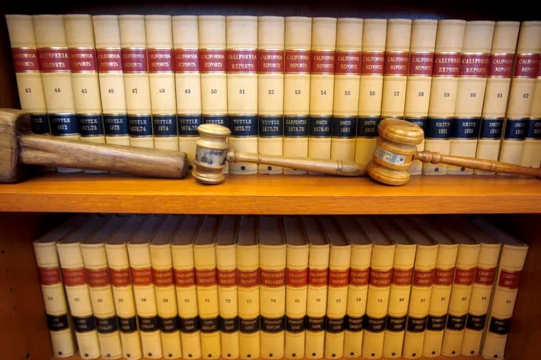 File photo of gavels and law books. A Philadelphia man was sentenced to 45 years in prison for sex trafficking three teenagers.