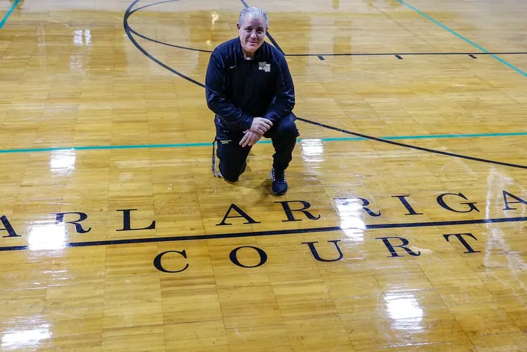 Neumann Goretti honors head basketball coach Carl Arrigale poses here1 before the varsity team's matchup against Lansdale Catholic in South Philadelphia, Monday, January 8, 2024.